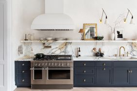 Kitchen with marble backsplash and blue cabinets