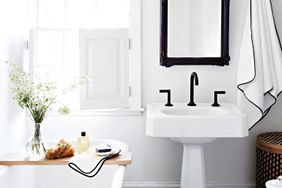 A white bathroom with black fixtures