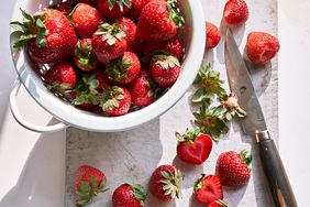 bowl of fresh strawberries on cutting board