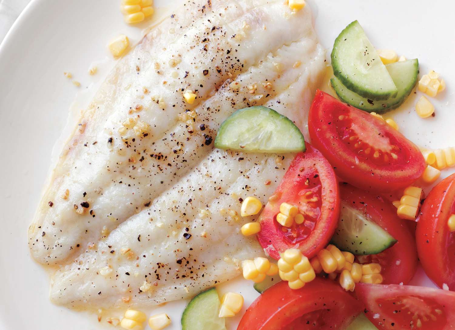 broiled fish with corn, tomatoes and cucumber