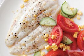 broiled fish with corn, tomatoes and cucumber