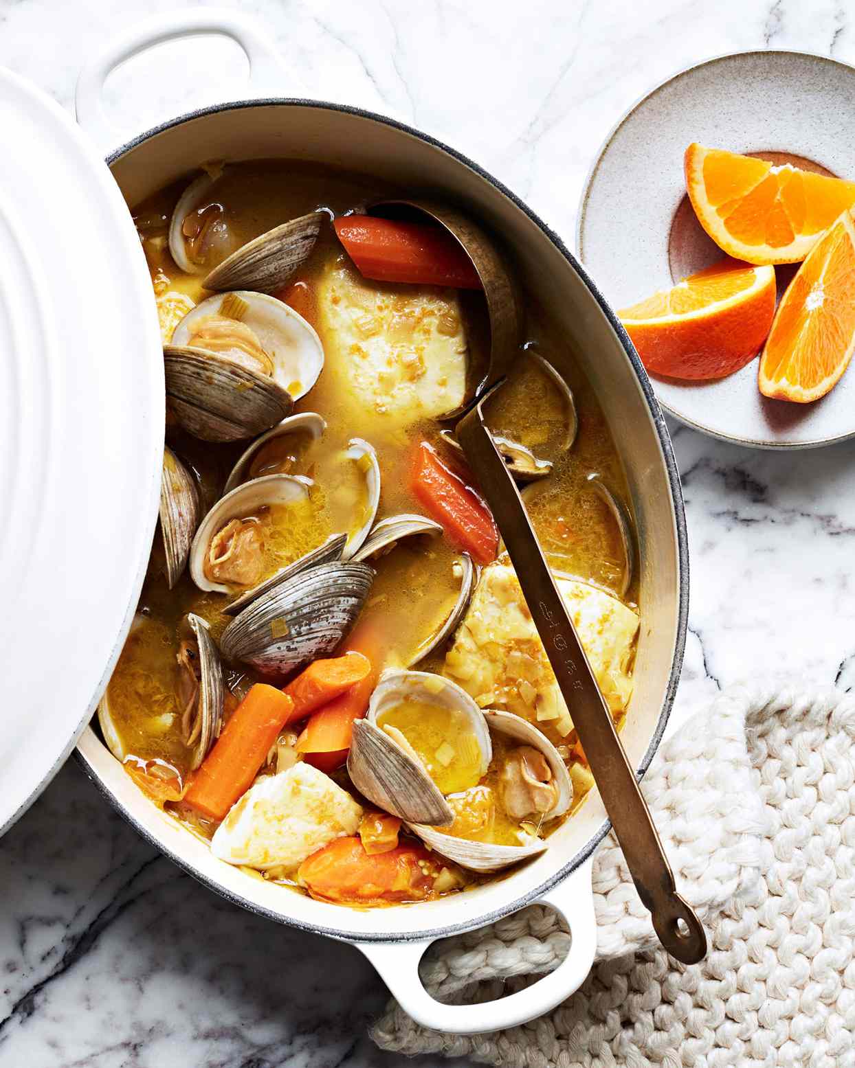 clams and white fish in carrot and saffron broth