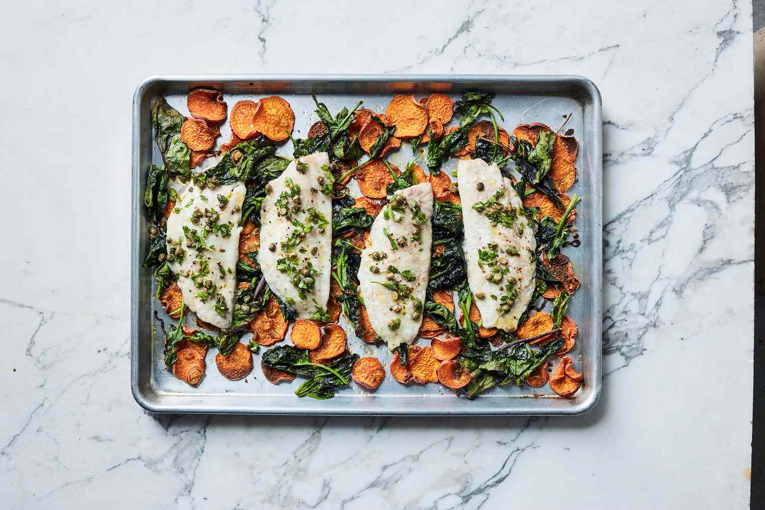 fish and vegetables on baking sheet