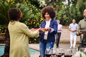 friends bringing food to potluck