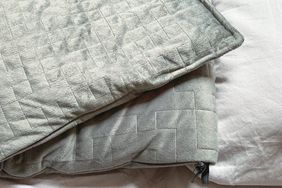 Grey weighted blanket on bed