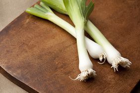 a few leeks on a cutting board