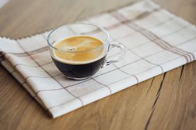 Shot of espresso sitting on a kitchen towel. 