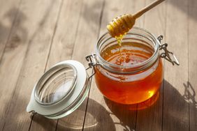 jar of honey and wood stick