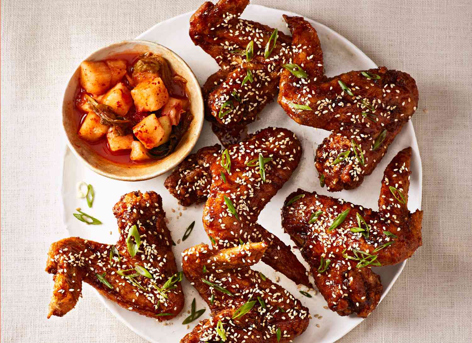 overhead view of korean fried chicken wings on white plate