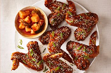 overhead view of korean fried chicken wings on white plate