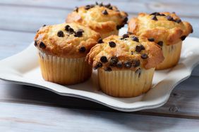 Four chocolate chip muffins from above over a table