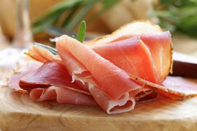 parma ham sliced on a wooden board