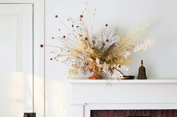 bouquet of dried flowers on a fireplace mantle