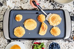 Electric griddle with pancakes and fruit