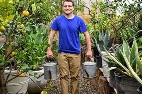 Martha's head gardener, Ryan McCallister, carrying compost tea in her greenhouse.