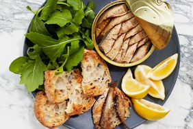 tinned fish with toasts, arugula, and lemon