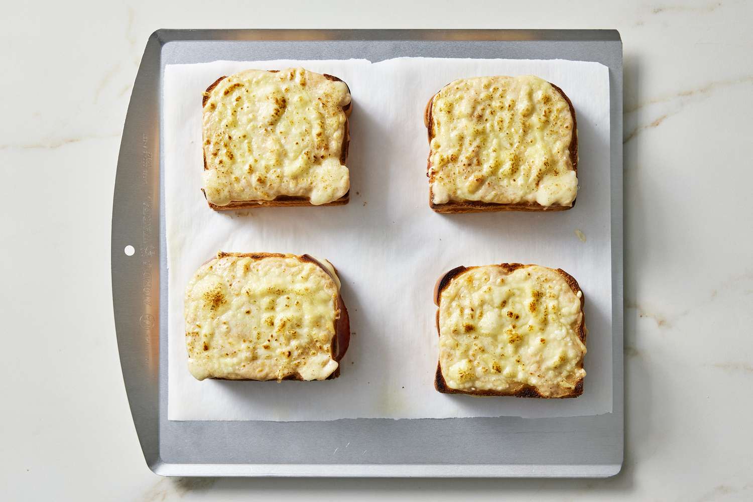 broiled croque monsieur on baking sheet