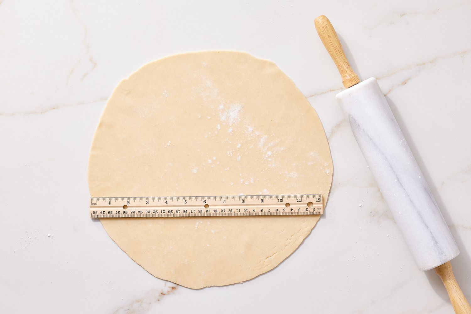 Roll out and slice pie crust for Broccoli Cheddar quiche