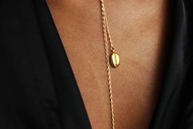 cowrie and infinity necklace by Omi Woods