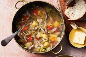 overhead view of a pot of pork cabbage stew with ladle