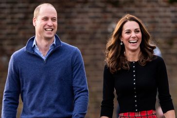 prince william and kate middleton walking outside smiling