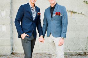 grooms wearing blue gray accented wedding suits with red boutonnieres