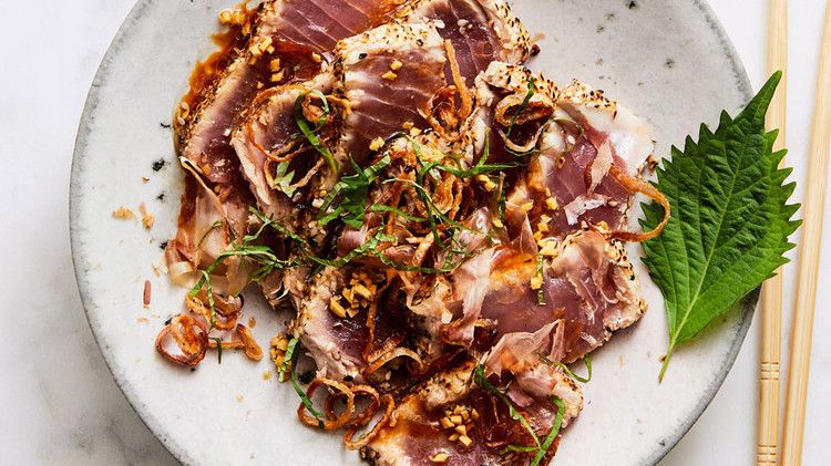 Sesame-Crusted Tuna Tataki on plate next to chop sticks