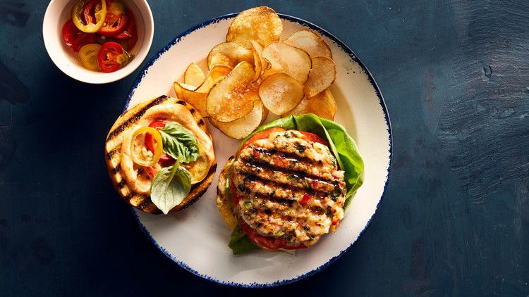 shrimp burgers served with sliced tomatoes