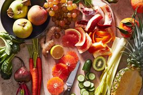 cutting board with citrus ginger cucumber beet oranges