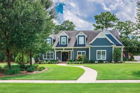 traditional lawn in front of blue house