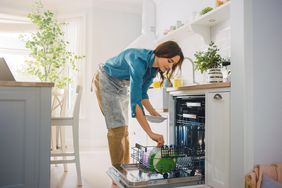 Woman loading dishwasher