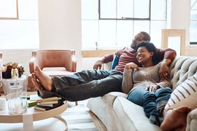 young couple watching movie on couch