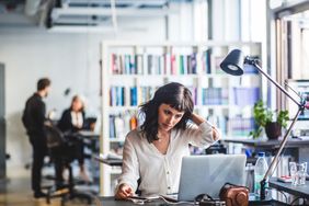 woman working at desk with computer