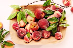 Wooden bowl with peaches